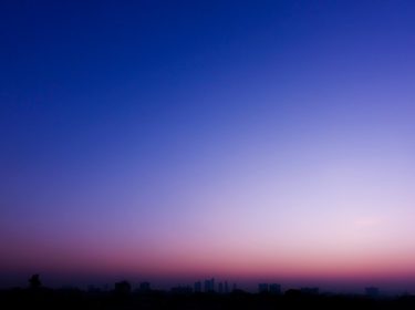 Beautiful twilight sky with blue and pink gradient over city silhouette background. horizontal shape, copy space (High resolution), real photo